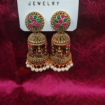 Gold Finish Bell Jhumkas with Pink and Green Geometric Accent